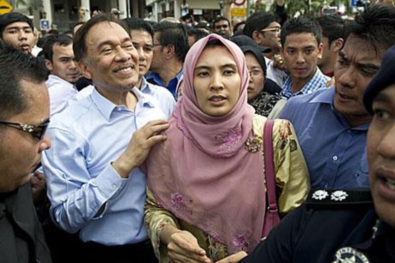 Anwar Ibrahim, the opposition leader, smiles outside of court with his daughter, Nurul Izzah, after being cleared in a sodomy trial which has gripped Malaysian politics.
