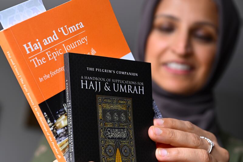 Saadiha Khaliq with books she read to prepare for her pilgrimage, in Murfreesboro, Tennessee.  The Khaliq family plan to travel together to Makkah in Saudi Arabia for Hajj. AP Photo