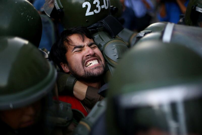 A demonstrator in Santiago, Chile, is detained during a protest demanding an end to profiteering in the education system. Ivan Alvarado / Reuters