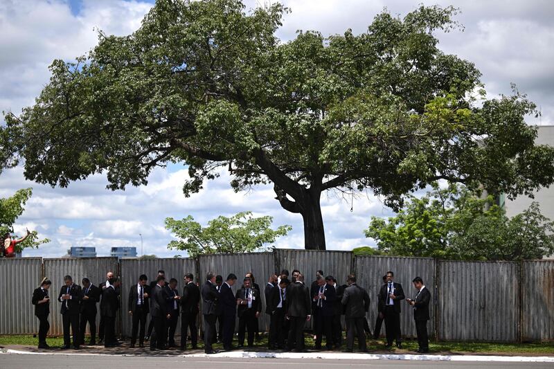 Security agents find shade under a tree before the inauguration of President Luiz Inacio Lula da Silva in Brasilia. There were security concerns in the lead-up to the ceremony. AFP