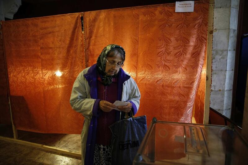 An elderly woman prepares to cast her vote at a polling station during a referendum in the eastern Ukrainian city of Slaviansk. Yannis Behrakis/Reuters