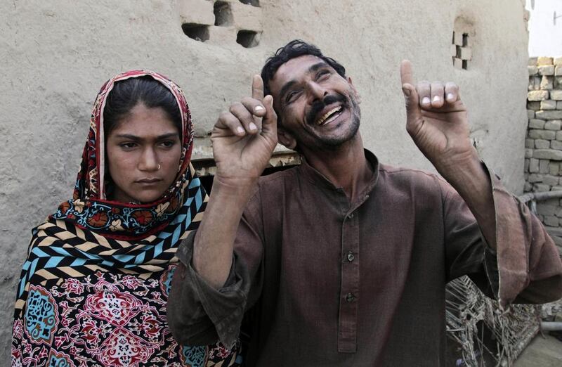 Mohammad Ramzan, 36, with his teenage wife Saima in Jampur, Pakistan. Saima’s father gave her as a bride to Mohammad so that he could marry the groom’s sister, a practice of exchanging girls that is entrenched in conservative regions of Pakistan. K M Chaudhry / AP Photo