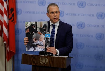 Israeli ambassador to the UN, Gilad Erdan, holds up a photograph of an Israeli woman with a Hamas fighter. EPA
