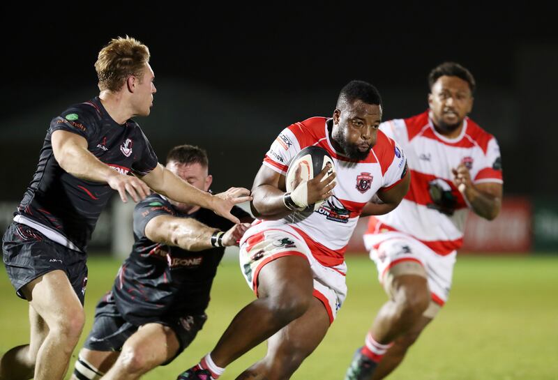 Dubai Tigers' Deanne Makoni attempts to shrug off a tackle during the game against Dubai Exiles.