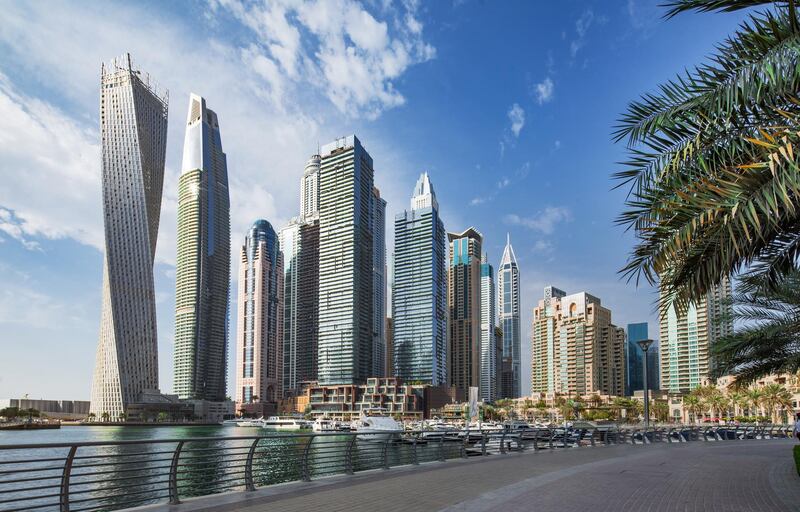 Luxurious Dubai marina skyscrapers and yachts at blue hour