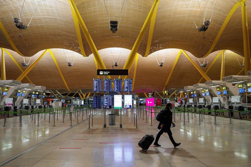 A traveler carries their luggage through Adolfo Suarez-Madrid Barajas international airport in Spain. EPA