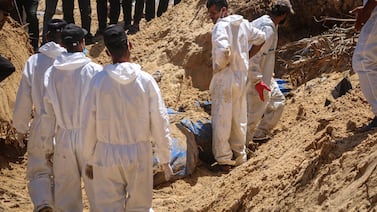 (EDITORS NOTE: Image depicts death. ) Palestinian health workers recover bodies from a mass grave at the Nasser Medical Hospital compound in Khan Younis, southern Gaza, on Sunday, April 21, 2024.  More than 34,000 Palestinians have died, according to the Hamas-run health authority. Photographer: Ahmad Salem / Bloomberg