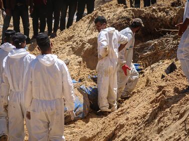 (EDITORS NOTE: Image depicts death. ) Palestinian health workers recover bodies from a mass grave at the Nasser Medical Hospital compound in Khan Younis, southern Gaza, on Sunday, April 21, 2024.  More than 34,000 Palestinians have died, according to the Hamas-run health authority. Photographer: Ahmad Salem / Bloomberg