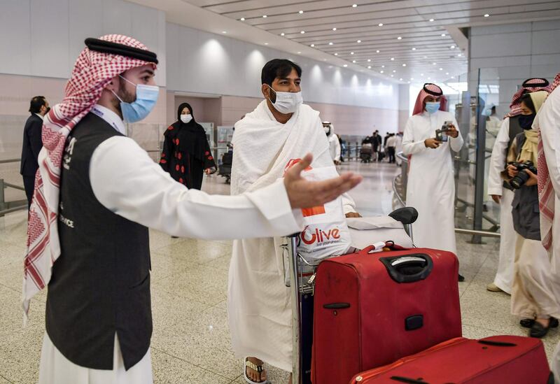 A mask-clad Pakistani traveller arriving in Saudi Arabia to perform the year-round Umrah. AFP