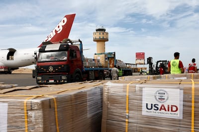 Workers unload humanitarian aid at Egypt's Arish Airport, bound for the Gaza Strip. AFP
