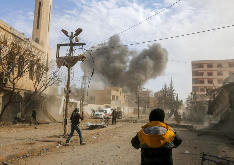 Smoke plumes rise from a regime air strike in Jisreen on February 8. Abdulmonam Eassa / AFP