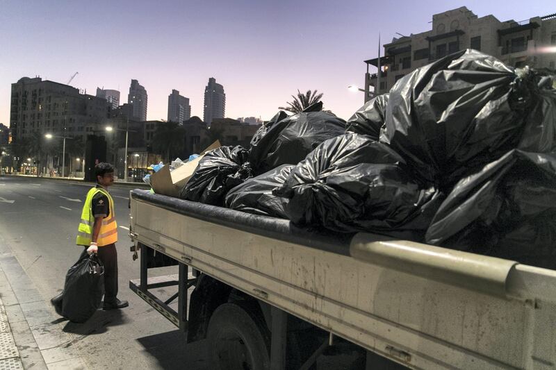 DUBAI, UNITED ARAB EMIRATES - Jan 1, 2018. 

On their seventh clean up rotation for the night, sweepers clean the streets at Downtown Dubai after New Year's Eve.

(Photo by Reem Mohammed/The National)

Reporter: Nawal Al Rawahi

Section: NA