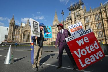 Protestors holding opposing Brexit views face off against each other outside parliament on Monday. AP.