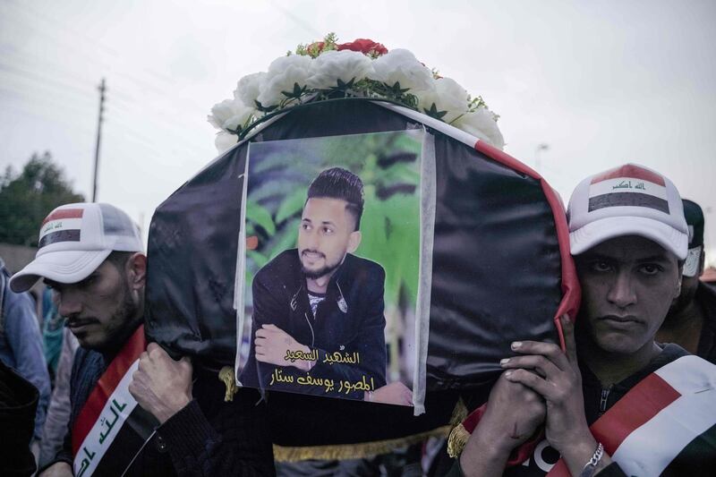 Iraqi mourners carry the coffin of Yussef Sattar, a local journalist and activist who was reportedly killed earlier this week while covering anti-government demonstrations, during his funeral in the capital Baghdad on January 21, 2020.  / AFP / Ayman HENNA
