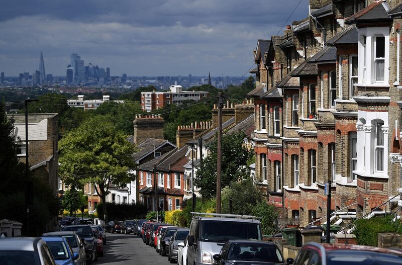 Rows of terraced houses and residential properties are pictured in south London on July 6, 2020, backdropped by the skyline of the City of London. - British media reported Monday that Britain's Chancellor of the Exchequer Rishi Sunak is set to outline plans to raise the threshold at which homebuyers pay Stamp Duty on their new properties, currently set at GBP 125,000. (Photo by DANIEL LEAL-OLIVAS / AFP)