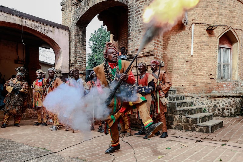 A Bamoun warrior responsible for the security of the Sultan King shoots into the air during the inauguration ceremony of the new Bamoun Kings Museum in Foumban. AFP