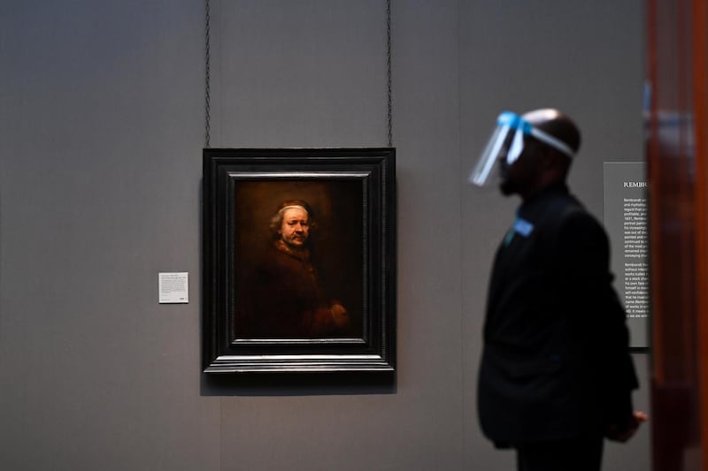 A security guard wears a protective face shield as The National Gallery prepares to open its doors to the public, for the first time since the coronavirus outbreak, in London. Reuters
