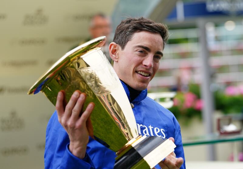 Jockey James Doyle with the trophy after winning the Platinum Jubilee Stakes on Naval Crown. PA