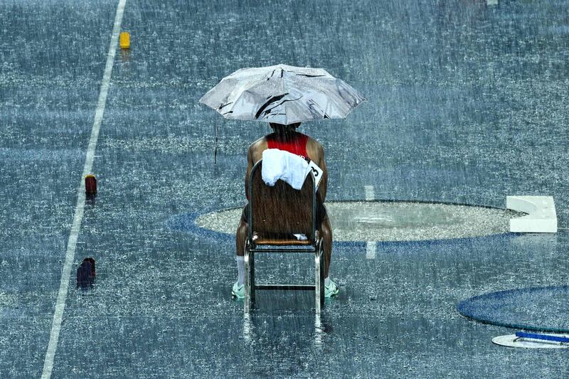 Thailand's Patsapong Amsam-ang waits during a break due to heavy rain in the men's pole vault final at the 32nd South-east Asian Games in Phnom Penh, Cambodia. AFP