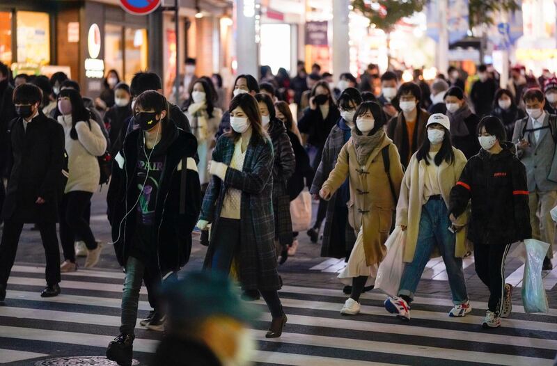 epa08902253 Pedestrians walk through a Ikebukuro street in Tokyo, Japan, 24 December 2020 after Tokyo marked new high record 888 cases of the COVID-19 Coronavirus infections per day. The COVID-19 infection cases in Japan has topped 200,000 on 21 December 2020.  EPA/KIMIMASA MAYAMA