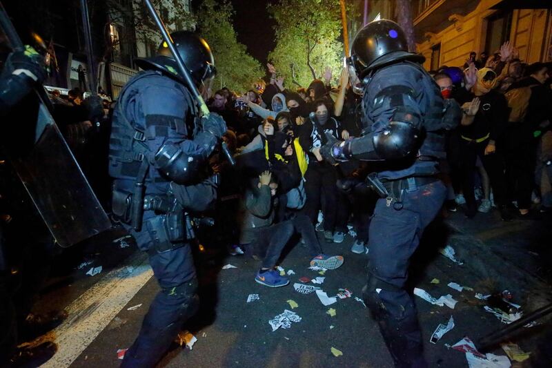 Protesters clash with Catalan regional police 'Mossos D'Esquadra' officers during a protest in front of the Spanish Government delegations in Barcelona.  AFP