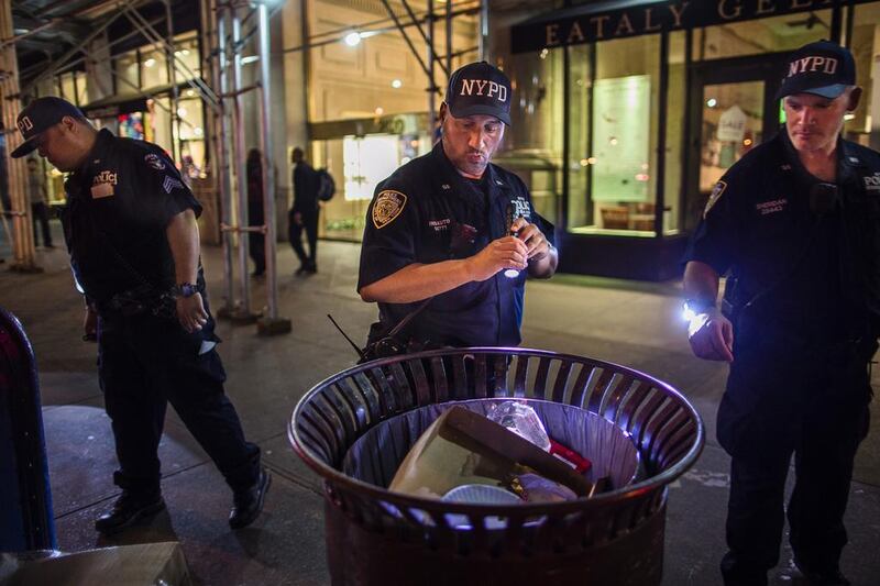 Police officers look for suspicious packages along Fifth Avenue near the scene of an explosion on West 23rd Street and 6th Avenue in Manhattan's Chelsea neighbourhood. Officials said more than two dozen people were injured. Most of the injuries were minor. Andres Kudacki / AP Photo