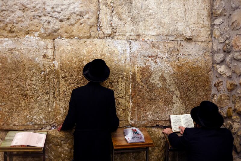 Jewish worshippers take part in Slichot, a prayer in which Jews repent and ask God to forgive their sins, before the start of Yom Kippur, at the Western Wall in Jerusalem's Old City. Reuters