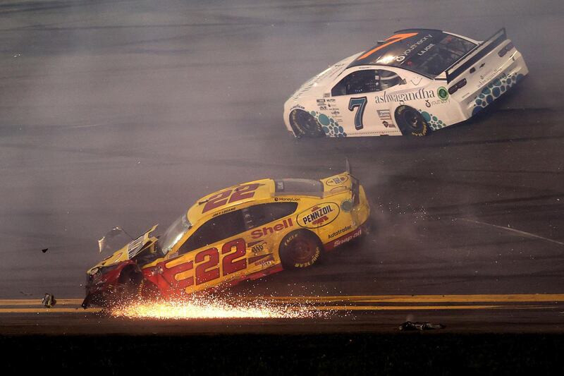 Team Penske's Joey Logano (No 22) veers off the track with Corey LaJoie (Spire Motorsports car No 7). AFP