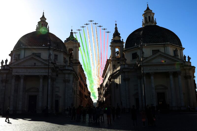 Planes of the Italian Air Force aerobatic unit Frecce Tricolori spread smoke with the colours of the Italian flag as they fly over Piazza de Popolo in Rome on November 4, 2023, as part of celebrations of National Unity and Armed Forces Day, marking the end of the First World War in Italy. AFP