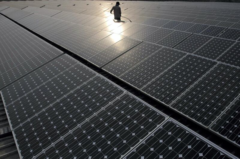 A maintenance worker cleans solar panels manufactured by Tata BP Solar India Ltd. at North Delhi Power Ltd.'s (NDPL) Keshavpuram power station in New Delhi, India, on Tuesday, June 14, 2011. India, which has about 300 sunny days a year on average, aims to generate 20,000 megawatts of solar power by 2022 from its Solar Mission program. Photographer: Andrew Caballero-Reynolds/Bloomberg