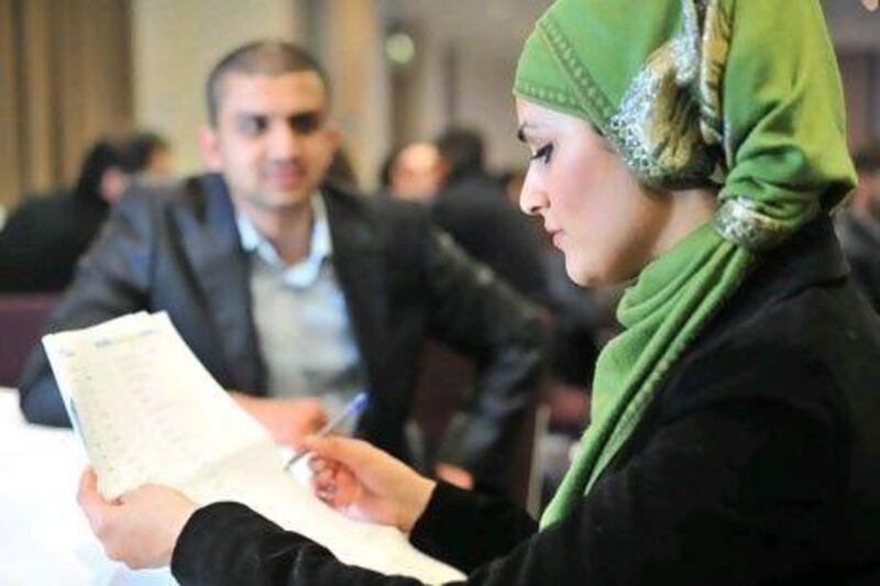 Nighat Bishir makes some notes on her checklist at a Muslim Marriage Event in east London. Jas Lehal for The National