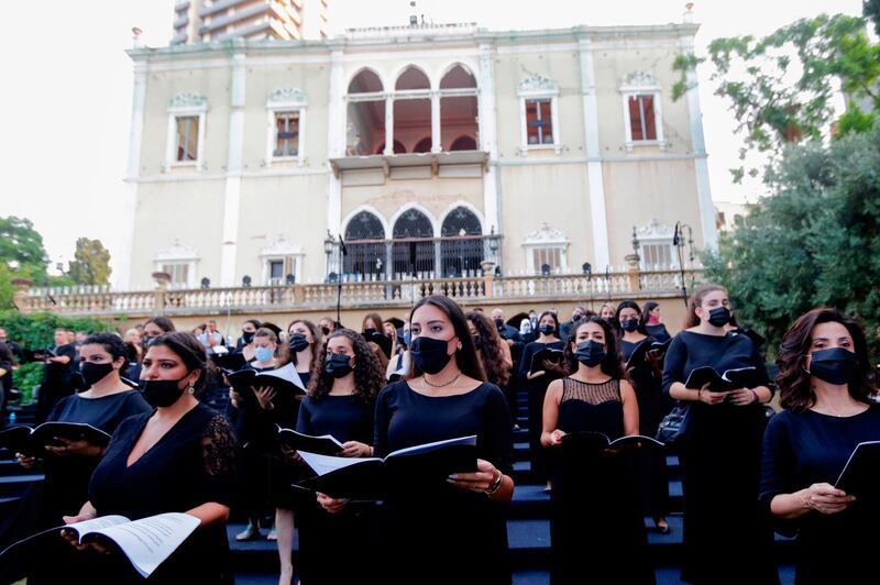 Choir singers wearing masks perform at a concert for the victims of August's deadly Beirut blast in the gardens of the damaged 19th-century Sursock Palace in Achrafieh in the Lebanese capital on September 20, 2020. AFP