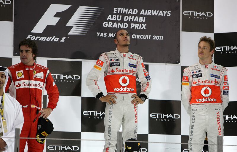 ABU DHABI, UNITED ARAB EMIRATES Ð Nov 13 : Left to Right -  Fernando Alonso ( 2nd position ) , Lewis Hamilton ( winner ) and Jenson Button ( 3rd position ) during the presentation ceremony of Etihad Airways Abu Dhabi Grand Prix 2011 at the Yas Marina Circuit in Abu Dhabi. ( Pawan Singh / The National ) For News and Sports. Story by Graham and Gary
