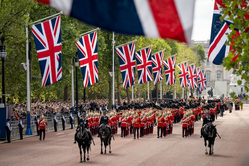 To the sombre notes of a military band, the coffin of Queen Elizabeth II is carried on a horse-drawn gun carriage from Buckingham Palace to Westminster Hall. Reuters