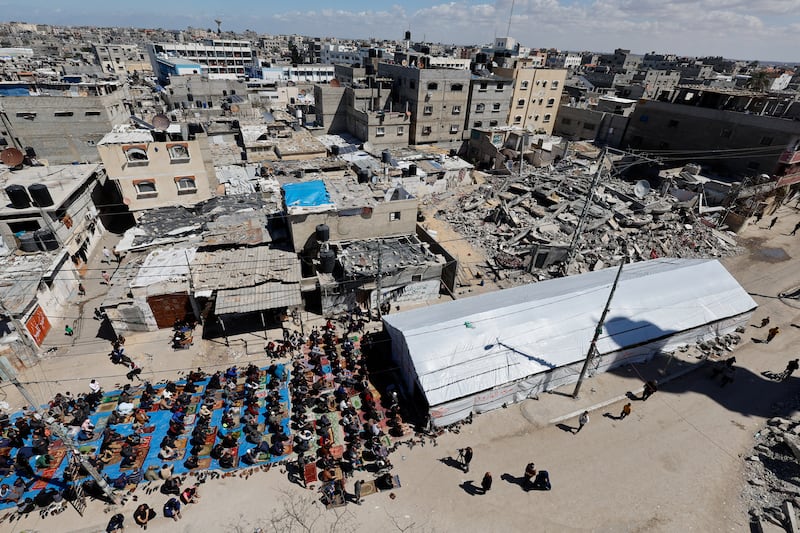 Palestinians perform the first Friday prayers of Ramadan near the ruins of a mosque in Rafah, southern Gaza. Reuters
