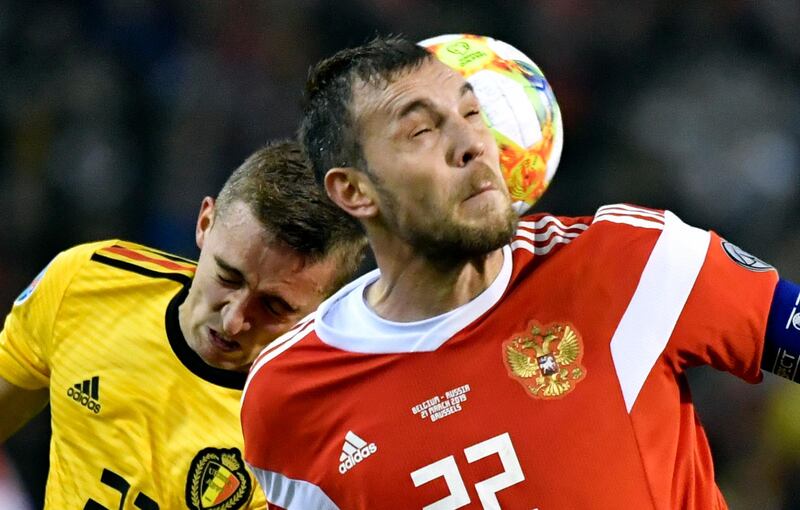 Belgium's Timothy Castagne, left, challenges Russia's Artem Dzyuba. AP Photo