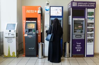 A customer uses an automatic teller machine. Payment processor Network International earned 73 per cent of its first half revenue in 2019 in the Middle East. Reem Mohammed/The National