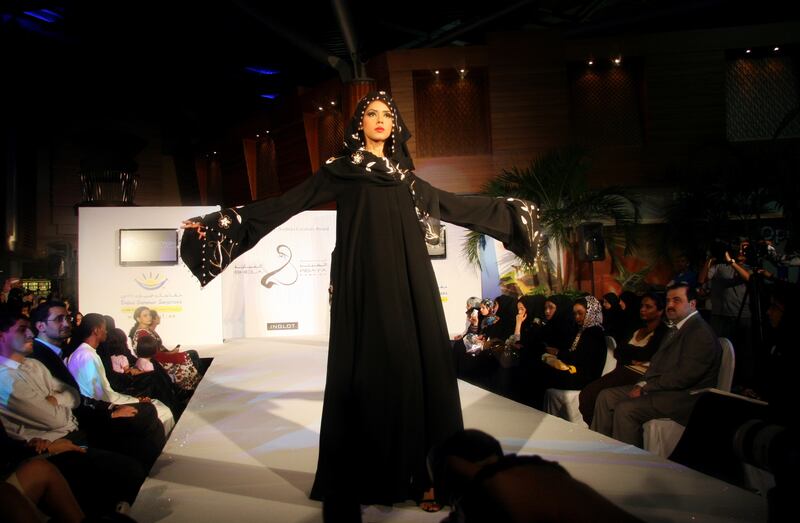 August 11 2008, DUBAI - A model pauses at the end of the runway to display her designer sheila and abaya at the Sheila and Abaya Fashion show at the BurJuman mall in Dubai on Aug 11 2008.  The fashion show was the last in a series of five days of shows that displayed the work of sheila and abaya designers from the UAE and other Gulf countries.  The event was part of the Dubai Shopping Festival's "Summer of Surprises." Edythe McNamee / The National *** Local Caption ***  em0811-abayafashion6.JPGna13au-abayafashion.JPG
