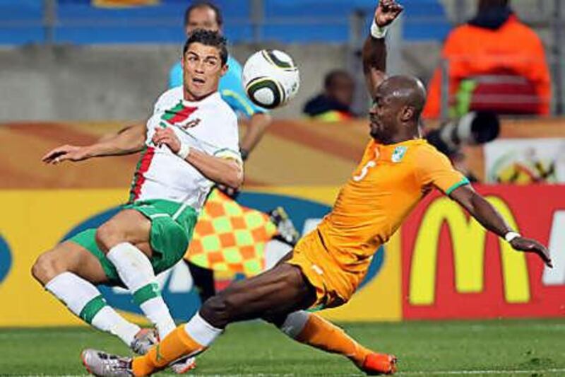 Portugal's Cristiano Ronaldo, left, tangles with Ivory Coast's Didier Zokora.