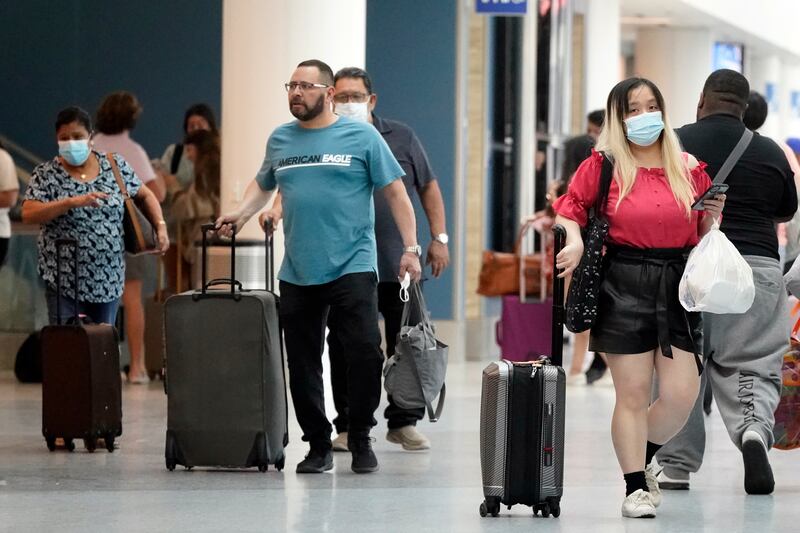 Travellers walk to their destinations at the Los Angeles International Airport. AP
