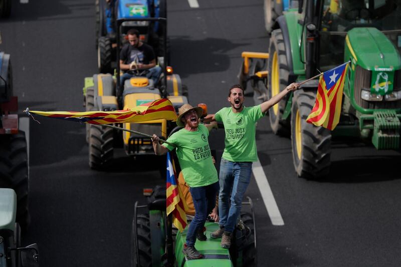 Protesters ride on tractors as they enter the city on the fifth day of protests over the conviction of a dozen Catalan independence leaders in Barcelona, Spain, Friday, October 18, 2019. AP Photo/Manu Fernandez
