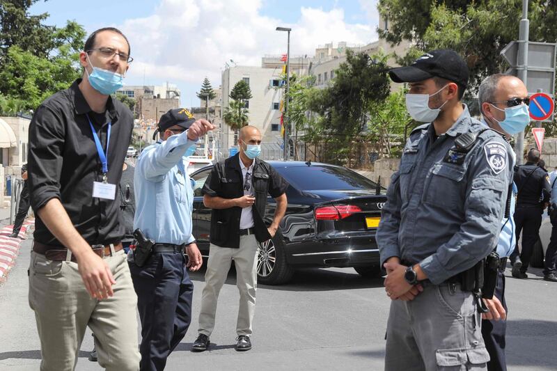 Israeli security forces stand guard as a convoy transporting Prime Minister Benjamin Netanyahu arrives at the district court of Jerusalem for a long-delayed corruption trial.  AFP