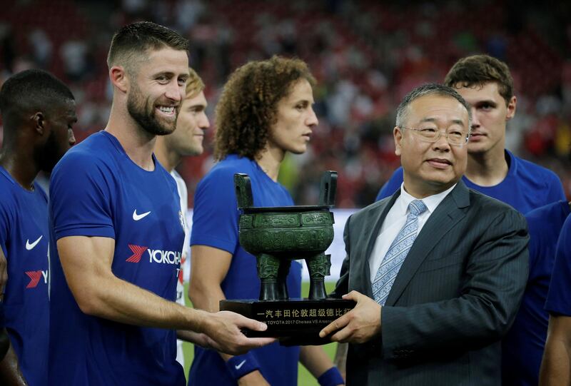 Chelsea's Gary Cahill receives the trophy at the end of the match. Jason Lee / Reuters