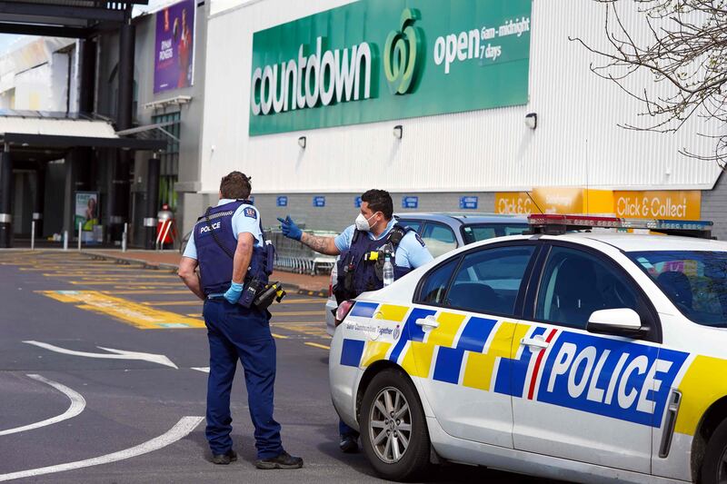 Police keep watch outside the Countdown supermarket at Lynn Mall in Auckland the day after an ISIS-inspired attacker injured seven people in a knife rampage before being shot dead by undercover police.  AFP