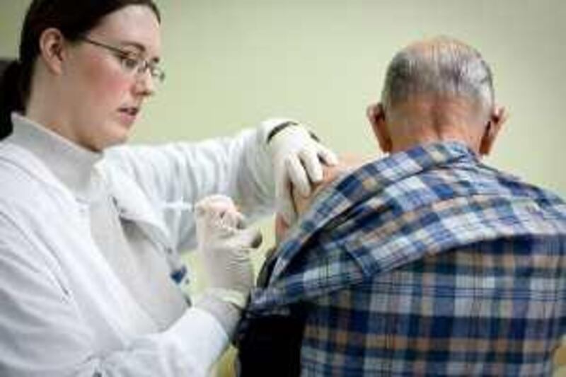 Anne Way, a nurse from Panhandle Health District, gives a flu shot to Gene "Rawhide" Hyde during the flu clinic Friday, Oct. 10, 2008 at Lake City Senior Center in Coeur d'Alene, Idaho.  (AP Photo/Coeur d'Alene Press, Jerome A. Pollos) ** MANDATORY CREDIT **
