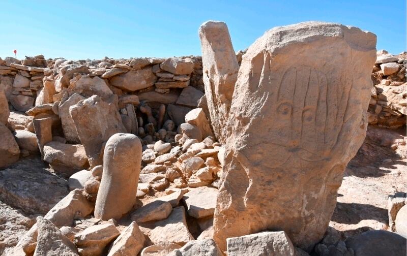 This photo provided by Jordan Tourism Ministry shows two carved standing stones at a remote Neolithic site in Jordan’s eastern desert.   A team of Jordanian and French archaeologists said Tuesday, Feb.  22, 2022,  that it had found a roughly 9,000-year-old shrine.   The ritual complex was found in a Neolithic campsite near large structures known as “desert kites," or mass traps that are believed to have been used to corral wild gazelles for slaughter.  (Tourism Ministry via AP)