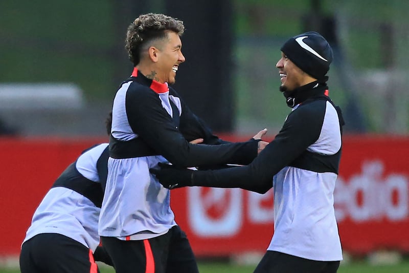 Liverpool's Roberto Firmino and Fabinho share a joke. AFP