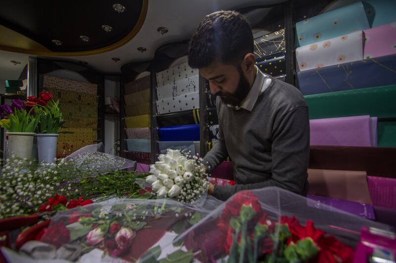 Khaled wraps a bouquet of white tulips inside his shop in Idlib. He said that several years ago there was no room for people to celebrate because of the intensity of the bombing and the permanent displacement, but now the situation is calmer.