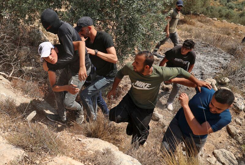 Palestinian protesters carry an injured youth amid clashes with Israeli security forces in the village of Beita, south of Nablus, in the occupied West Bank, on May 28. Despite this, 41 per cent of young Palestinians polled in the Arab Youth Survey were optimistic about their future. Photo: Jaafar Ashtiyeh / AFP