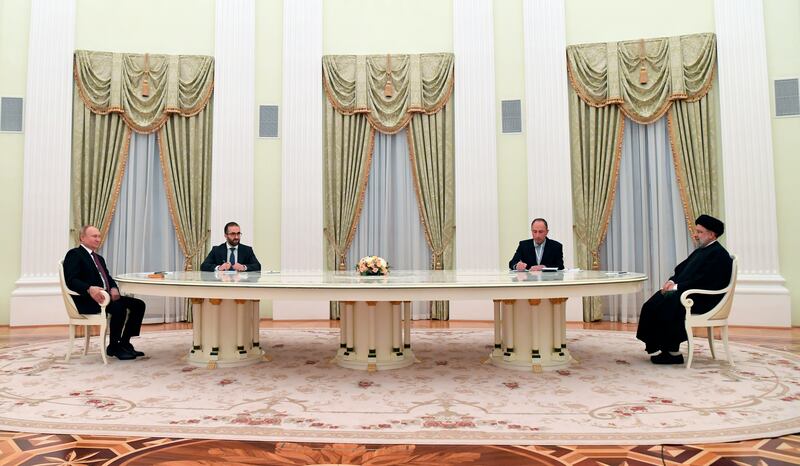 Russian President Vladimir Putin, left, and Iranian President Ebrahim Raisi, right, talk in the Kremlin in Moscow, Russia.  AP